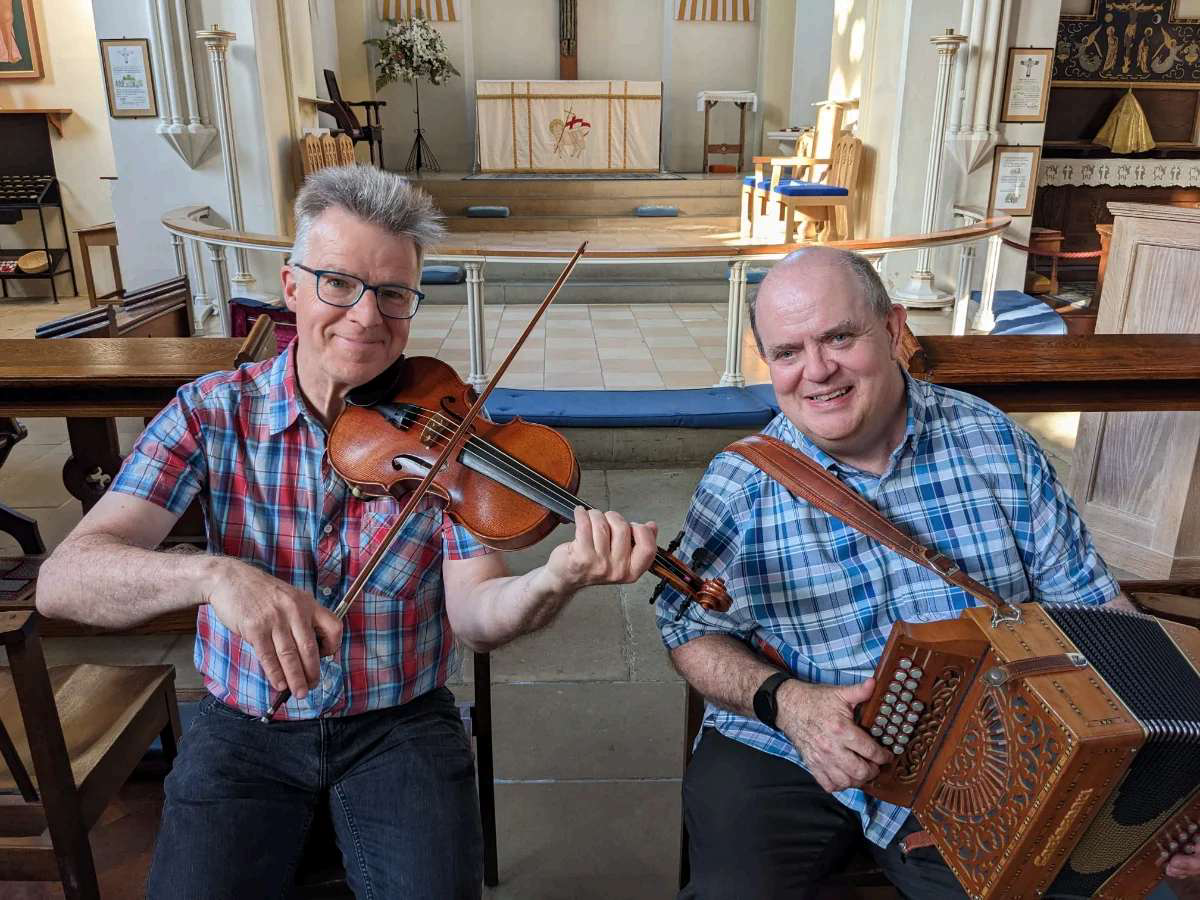 Mark Prescott (violin) and Clive Williams (melodeon) inside a church